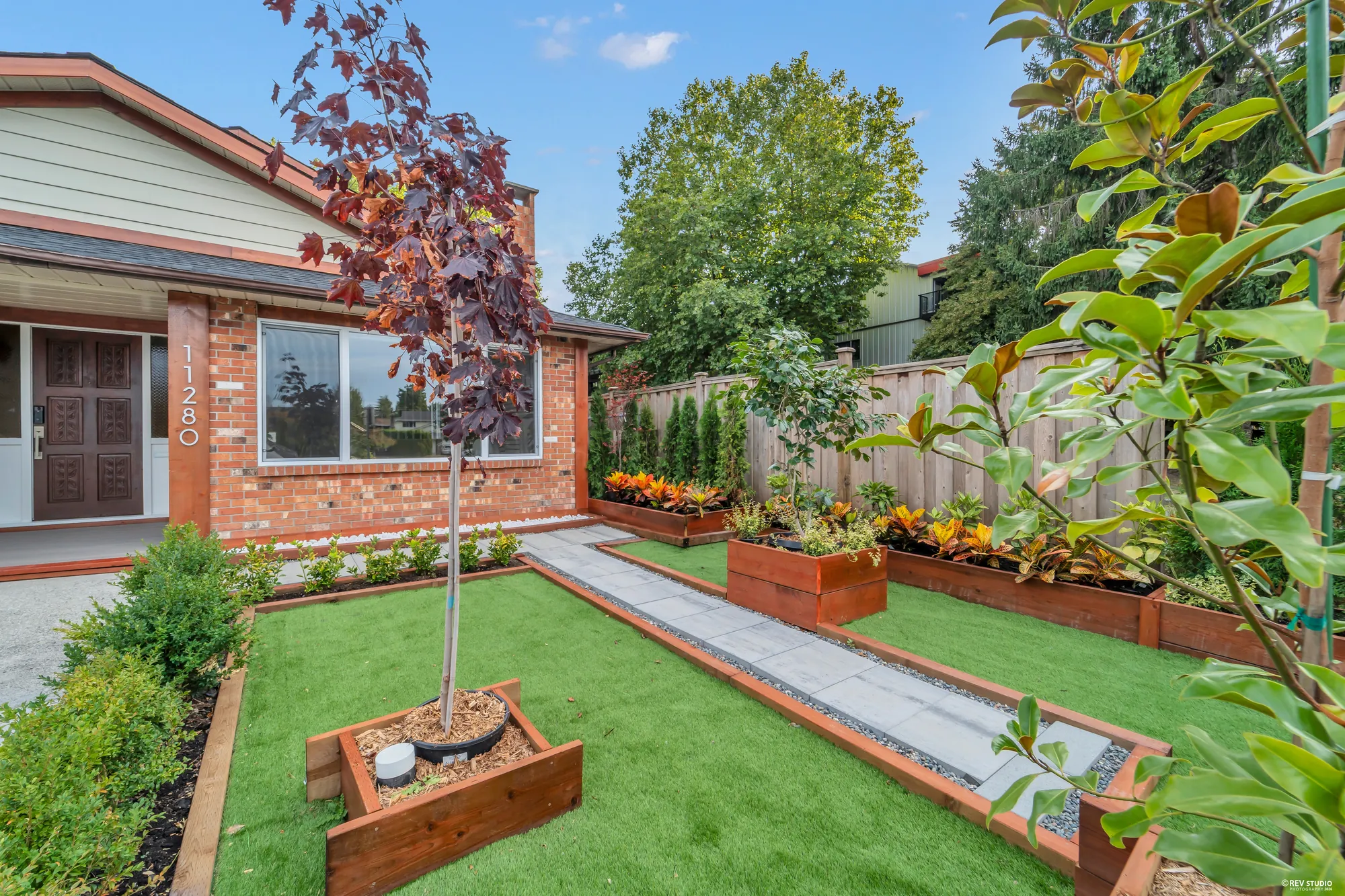 The front beds and the turf from beside the door, a paved strip between them