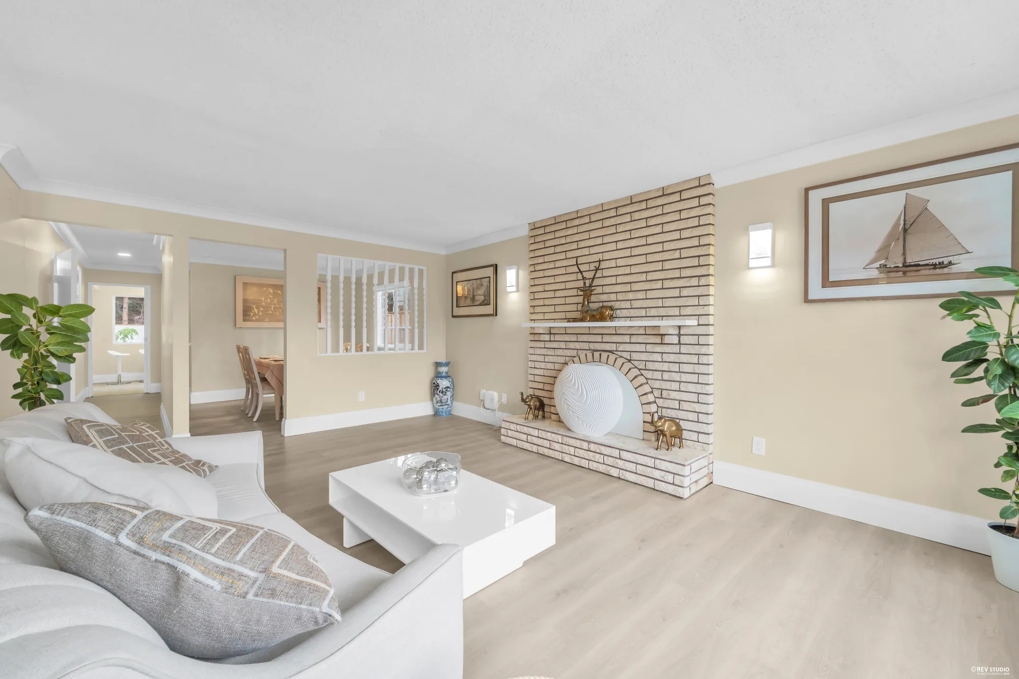 Seating in the living room with the fireplace to the right and the screen behind